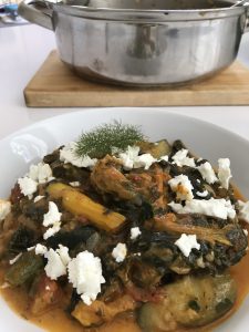 Finish kolokithokorfádes with some crumbled feta